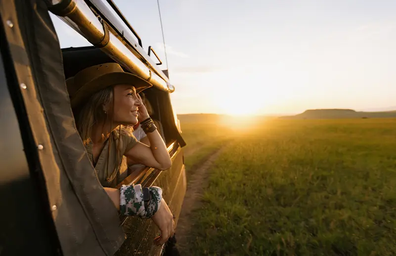 smiling woman out of car window